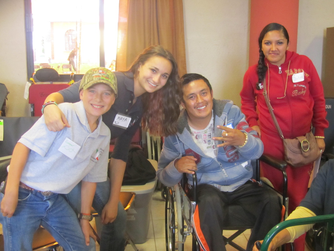 Everyone smiles when the wheelchairs are donated