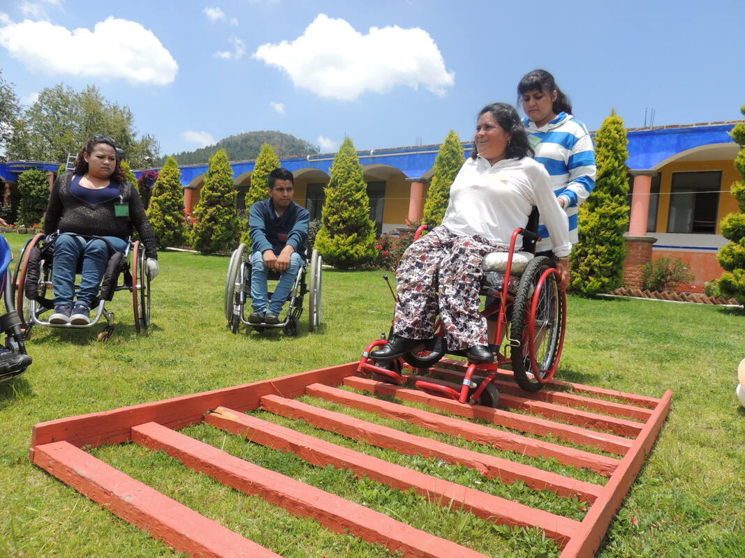 World Access Project's  U.S. team takes a photo break from outfitting wheelchairs
